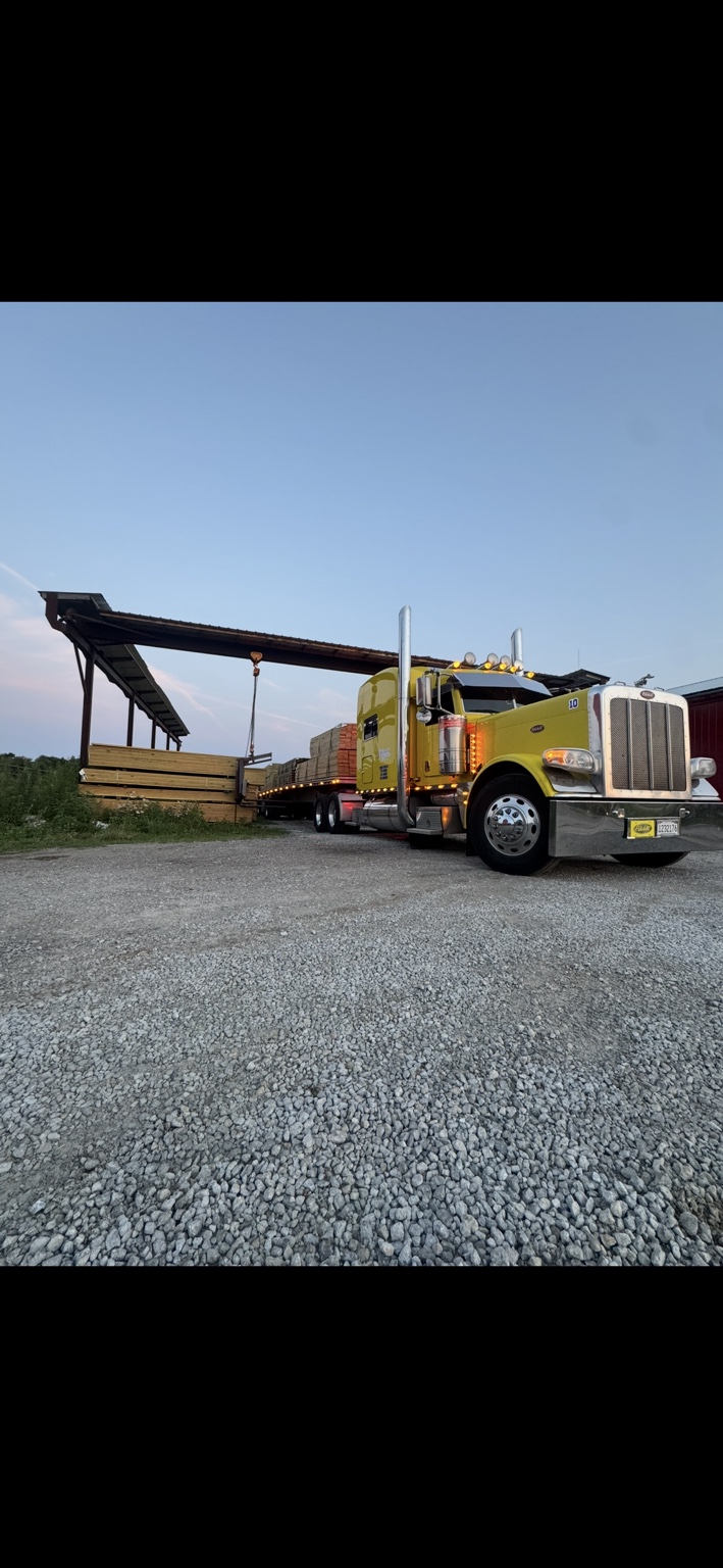 Yellow S. Tillery truck with flatbed lumber load at a loading yard